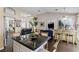 Spacious kitchen with a black counter top island with seating that connects to an adjacent living space at 8736 Vista Ladera Ct, Las Vegas, NV 89147