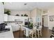 Open-concept kitchen with white cabinetry, stainless steel appliances, and a center island for food preparation at 8736 Vista Ladera Ct, Las Vegas, NV 89147