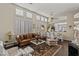 Bright living room with plantation shutters, elegant furnishings, and a seamless flow into the dining area at 8736 Vista Ladera Ct, Las Vegas, NV 89147