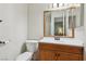 Bathroom featuring a wood vanity, a sink, a toilet, and a large mirror at 8805 Pavia Dr, Las Vegas, NV 89117