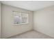 Bright bedroom featuring neutral walls, carpet, and a window for natural light at 8805 Pavia Dr, Las Vegas, NV 89117