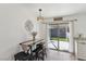 Bright dining area with a sliding glass door, table with seating, and neutral paint at 8805 Pavia Dr, Las Vegas, NV 89117