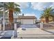 Charming home featuring a spacious driveway framed by mature palm trees at 8805 Pavia Dr, Las Vegas, NV 89117