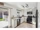 Bright kitchen with stainless steel appliances and a view to the outdoor covered patio at 8805 Pavia Dr, Las Vegas, NV 89117