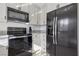 Modern kitchen featuring stainless steel appliances, white cabinetry, and granite countertops at 8805 Pavia Dr, Las Vegas, NV 89117