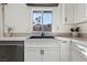 Renovated kitchen with stainless steel appliances, granite countertops, and white cabinetry at 8805 Pavia Dr, Las Vegas, NV 89117