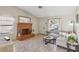 Bright living room featuring a large decorative brick fireplace, neutral paint, tile floors and seating at 8805 Pavia Dr, Las Vegas, NV 89117