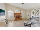 Bright living room featuring a decorative brick fireplace, neutral paint, tile floors and comfortable seating at 8805 Pavia Dr, Las Vegas, NV 89117