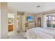 Main bedroom offering a view to the ensuite bath, decor, and a closet for ample storage at 8805 Pavia Dr, Las Vegas, NV 89117