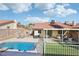 Sunny backyard featuring a sparkling blue pool, patio, and cozy seating area, perfect for outdoor relaxation and entertainment at 8805 Pavia Dr, Las Vegas, NV 89117