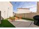 Inviting backyard featuring a patio, artificial turf, and string lights, perfect for outdoor entertaining at 8872 Hampton Green Ave, Las Vegas, NV 89129