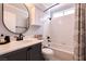 Bright bathroom with marble countertop, framed mirror and shower-tub combination at 8872 Hampton Green Ave, Las Vegas, NV 89129