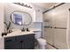 Stylish bathroom with gray cabinets, marble countertops, and glass shower door at 8872 Hampton Green Ave, Las Vegas, NV 89129