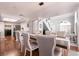 Open-concept dining area with modern lighting, connecting seamlessly to the kitchen and living room at 8872 Hampton Green Ave, Las Vegas, NV 89129