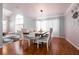 Bright dining room with hardwood floors, modern lighting, and views into the living space at 8872 Hampton Green Ave, Las Vegas, NV 89129