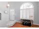 Bright foyer with an arched window, white tile entry, and hardwood floors adds a stylish touch at 8872 Hampton Green Ave, Las Vegas, NV 89129