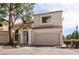 Charming townhome with a tile roof, blue door, and two-car garage in a well-maintained community at 8872 Hampton Green Ave, Las Vegas, NV 89129