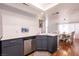 Kitchen featuring stainless steel dishwasher, gray cabinetry, and an open layout at 8872 Hampton Green Ave, Las Vegas, NV 89129