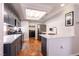 Bright kitchen with gray cabinetry, modern appliances, and hardwood floors at 8872 Hampton Green Ave, Las Vegas, NV 89129