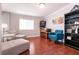 Inviting living room with hardwood floors, comfortable seating, and a pinball machine at 8872 Hampton Green Ave, Las Vegas, NV 89129