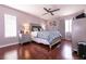 Cozy main bedroom features a ceiling fan, wood floors and ample natural light at 8872 Hampton Green Ave, Las Vegas, NV 89129