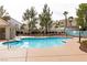 Relaxing community pool area with ample seating and lush landscaping, ideal for leisurely afternoons at 8872 Hampton Green Ave, Las Vegas, NV 89129