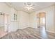 Cozy main bedroom featuring hardwood floors, ceiling fan, and ensuite bath at 9002 Purple Leaf St, Las Vegas, NV 89123