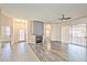 Open-concept living room with hardwood floors, fireplace, and sliding glass doors at 9002 Purple Leaf St, Las Vegas, NV 89123