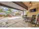 Covered patio seating area overlooking a sparkling in-ground swimming pool and landscaped backyard at 9071 Ravenhurst St, Las Vegas, NV 89123