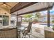 Backyard covered patio seating area with view to a pool and landscaped yard at 9071 Ravenhurst St, Las Vegas, NV 89123