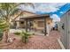 Beautiful landscaped backyard with covered patio, grilling area, and decorative wall art at 9071 Ravenhurst St, Las Vegas, NV 89123