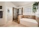 Bright primary bathroom featuring a soaking tub and a glass-enclosed shower at 9071 Ravenhurst St, Las Vegas, NV 89123