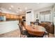 Bright dining area adjacent to the kitchen with decorative chairs and a round wooden table at 9071 Ravenhurst St, Las Vegas, NV 89123