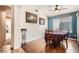 Cozy dining room with wood floors, adjacent to another room with tile at 9071 Ravenhurst St, Las Vegas, NV 89123