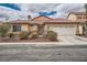 Charming single-story home with a well-maintained front yard and a two-car garage at 9071 Ravenhurst St, Las Vegas, NV 89123