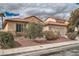 Inviting single-story home with a mature front yard and two-car garage at 9071 Ravenhurst St, Las Vegas, NV 89123