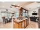 Open-concept kitchen with stainless appliances, granite countertops, and tile flooring at 9071 Ravenhurst St, Las Vegas, NV 89123