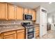 Bright kitchen with stainless steel oven range and microwave, with ample cabinet space at 9071 Ravenhurst St, Las Vegas, NV 89123