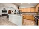 Bright kitchen with wooden cabinets, granite countertops, and stainless steel appliances at 9071 Ravenhurst St, Las Vegas, NV 89123