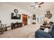 Comfortable living room with a ceiling fan, built-in shelving, and entertainment center at 9071 Ravenhurst St, Las Vegas, NV 89123