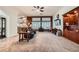 Comfortable living room area showcasing carpeting, ceiling fan, and natural light at 9071 Ravenhurst St, Las Vegas, NV 89123