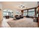 Open-concept living room that flows into a dining area, featuring tile and carpet flooring at 9071 Ravenhurst St, Las Vegas, NV 89123