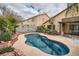 Private backyard showcasing a kidney-shaped pool, mature palm trees, and a low-maintenance desert landscape at 9071 Ravenhurst St, Las Vegas, NV 89123