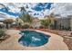 Sparkling in-ground pool with surrounding patio and landscaped backyard at 9071 Ravenhurst St, Las Vegas, NV 89123