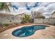 Inviting in-ground pool surrounded by lush landscaping and decorative backyard art at 9071 Ravenhurst St, Las Vegas, NV 89123