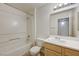 Bright bathroom featuring a tub/shower combo and wooden vanity at 950 Seven Hills Dr # 722, Henderson, NV 89052