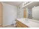 Bright bathroom with wooden cabinets and a shower reflected in the mirror at 950 Seven Hills Dr # 722, Henderson, NV 89052