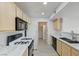 Bright kitchen with white marbled countertops, light wood cabinets, and modern appliances at 950 Seven Hills Dr # 722, Henderson, NV 89052