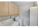 Practical laundry room with white washer, dryer, and ample storage at 950 Seven Hills Dr # 722, Henderson, NV 89052