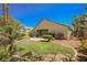 Backyard showcasing patio space with a well-manicured lawn and mature trees at 9725 La Cienega St, Las Vegas, NV 89183